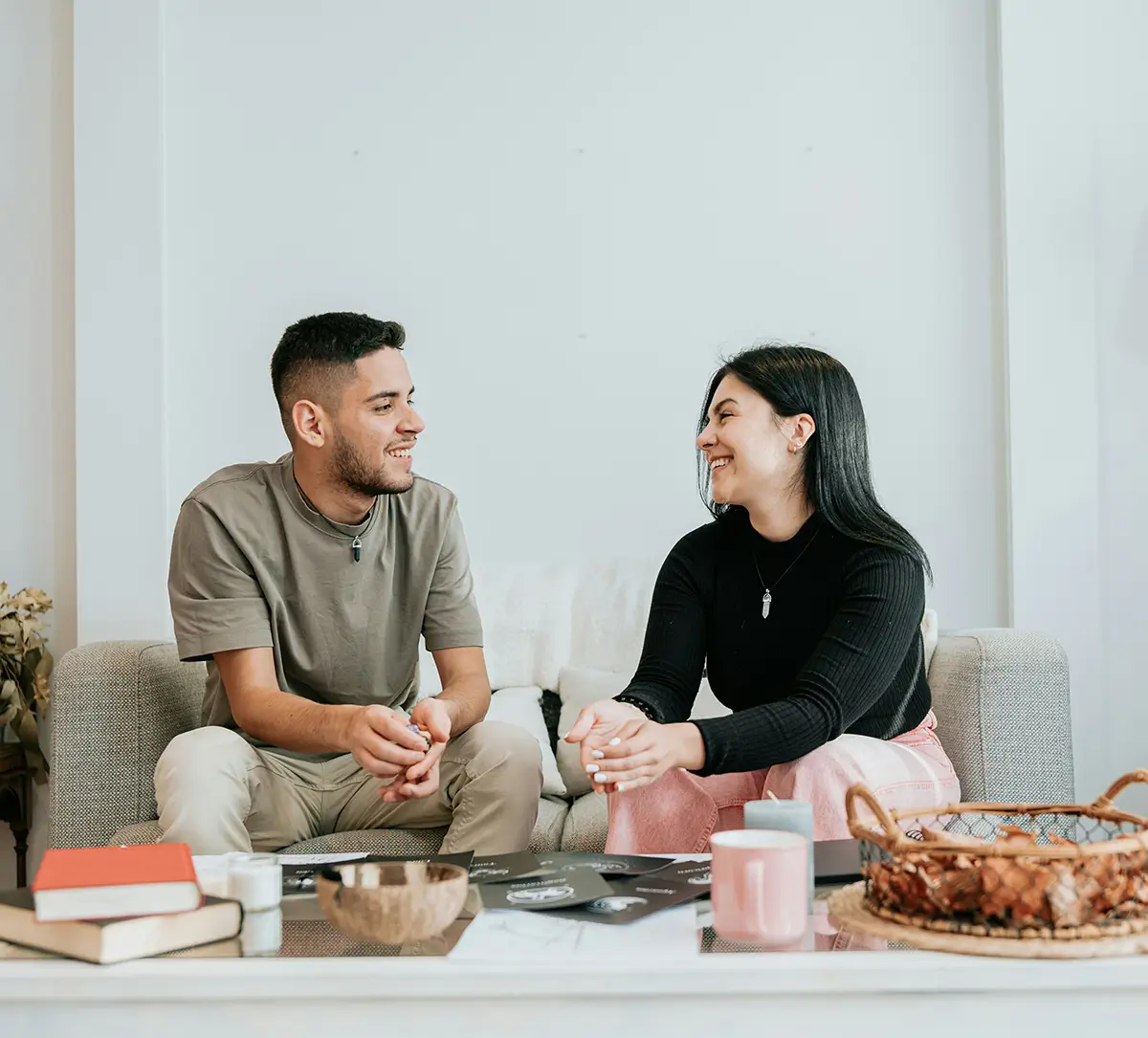 a young couple sit in their living room, enjoying each other's company