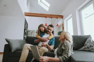 A family enjoying each other in their living room. The walls of the space are painted in white to give the room a light and clean feel