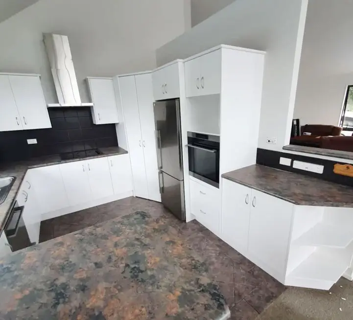 a kitchen area freshly painted in white
