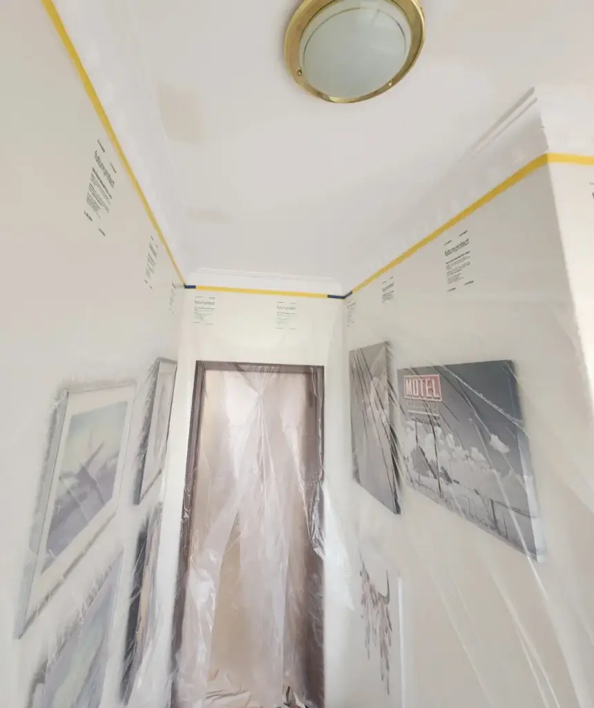 interior space with walls covered in protective sheets, so that the ceiling can be painted without causing damage